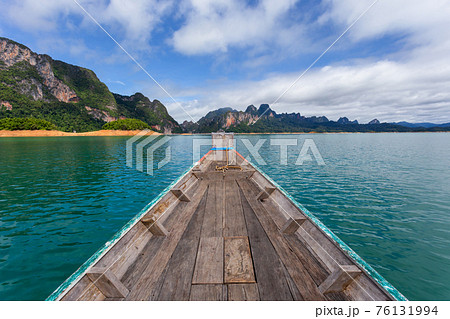 raditional longtail boat with beautiful scenery view in Ratchaprapha Dam at Khao Sok National Park 76131994