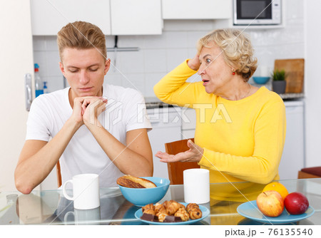 Sad son and unhappy mother quarrelling Sad son and unhappy mother quarrelling 76135540