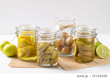 Homemade various pickled fruit in a glass jar on white background 76136096