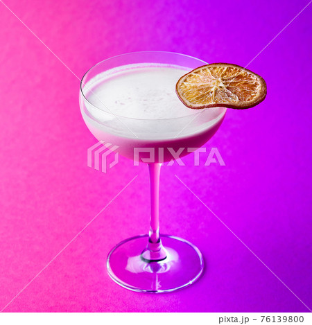 Closeup glass of milk liquor based cocktail on a purple background Closeup glass of milk liquor based cocktail on a purple background 76139800