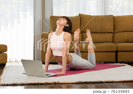 ノートPCの前でヨガのポーズをとる女性 ノートPCの前でヨガのポーズをとる女性 76139895