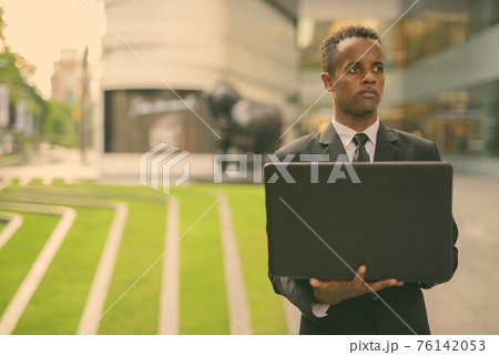 Young African businessman exploring the city of Bangkok, Thailand 76142053