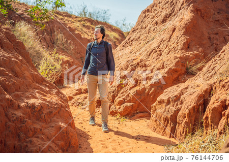 Man tourist in red canyon, resumption of tourism concept 76144706