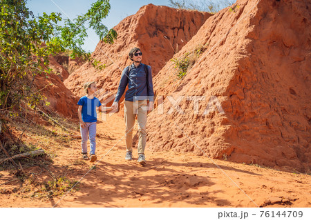Dad and son tourists in red canyon, resumption of tourism concept. Traveling with children concept 76144709