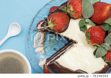 Homemade chocolate cake decorated with fresh strawberries and cup of coffee Homemade chocolate cake decorated with fresh strawberries and cup of coffee 76146504