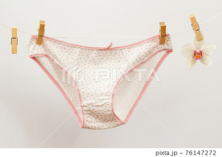 Beautiful white women's cotton panties on white background. Beautiful white women's cotton panties on white background. 76147272