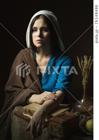 A woman in a retro dress. Historical reconstruction. 76148486