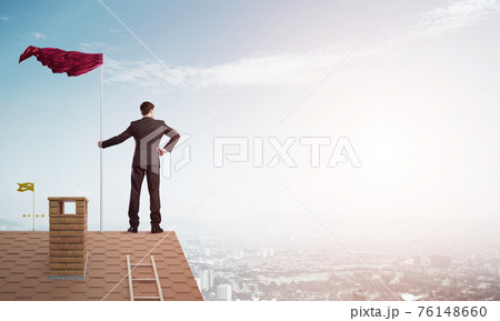 Young businessman with flag presenting concept of leadership. Mixed media Young businessman with flag presenting concept of leadership. Mixed media 76148660