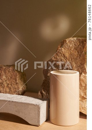 Stone and a piece of tile podium on a beige background 76148662