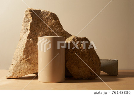 Stone and a piece of tile podium on a beige background 76148886