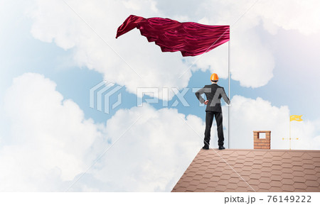 Young businessman with flag presenting concept of leadership. Mixed media Young businessman with flag presenting concept of leadership. Mixed media 76149222