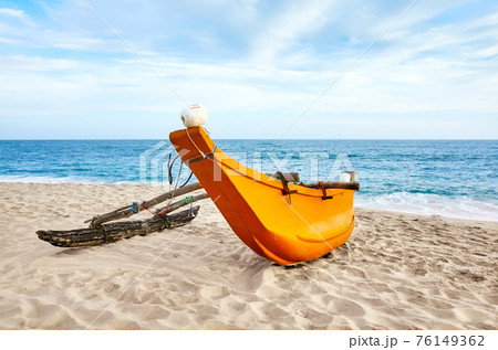 Small fishing boat on an empty beach, Sri Lanka. Small fishing boat on an empty beach, Sri Lanka. 76149362