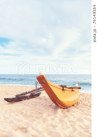Small fishing boat on an empty beach, color toning applied, Sri Lanka. 76149364