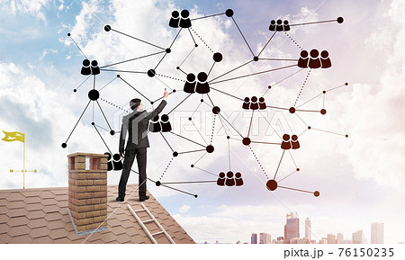 Businessman on house roof presenting networking and connection concept. Mixed media 76150235