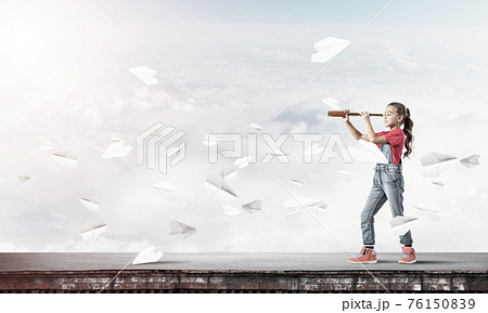 Concept of careless happy childhood with girl exploring this wor 76150839
