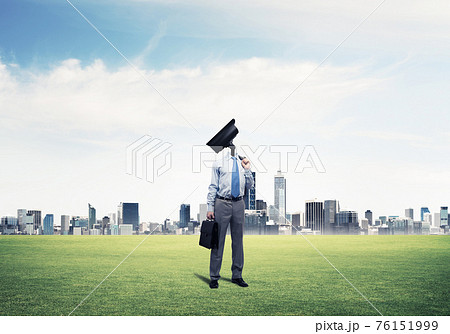 Camera headed man standing on green grass against modern citysca Camera headed man standing on green grass against modern citysca 76151999