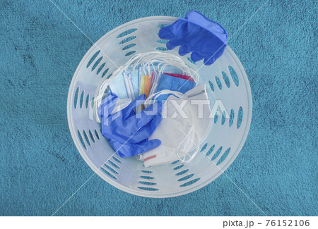 Medical masks and gloves thrown in the trash, end of quarantine and disease coronavirus COVID-19 concept. Selective focus 76152106