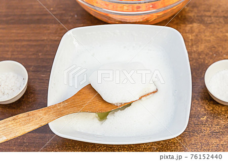 whipped egg whites on a wooden spatula ingredients making carrot muffins 76152440