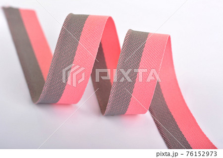 Pink and gray Cotton ribbon, roll textilies on bobbin. strapping tape and rope Lime Webbing with curl on white background. 76152973