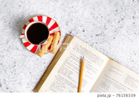 Coffee in a cup, cookies and a book 76156339