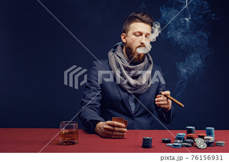 Stylish bearded Man playing in dark casino 76156931