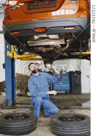 Checking car for serviceability in garage with tools on hoist Checking car for serviceability in garage with tools on hoist 76157271