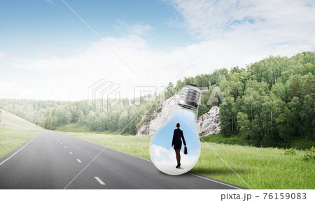 Businesswoman inside light bulb 76159083