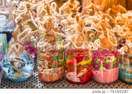 Plenty of small colorful decorative bottles on shelf Plenty of small colorful decorative bottles on shelf 76160287
