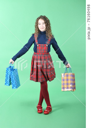 Child with a packaging checkered texture isolated on white background. Girl likes shopping on sale season. Holiday present, shopping. 76160498