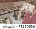Woman cooking with a kitchen robot preparing a homemade cake with sugar 76160639