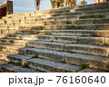 Ancient stone stairs illuminated by the sun and with shadows 76160640