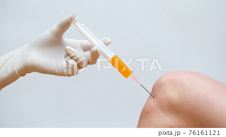 Doctor doing stem cell therapy on a knee with platelet-rich plasma injection. Doctor doing stem cell therapy on a knee with platelet-rich plasma injection. 76161121