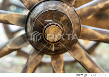 part of a wooden traditional wagon, wheel hub closeup part of a wooden traditional wagon, wheel hub closeup 76163285