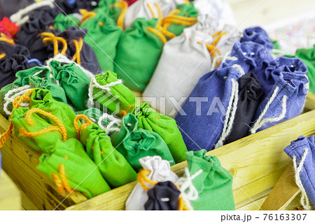 set of green bags with fragrant herbs folded in a wooden box set of green bags with fragrant herbs folded in a wooden box 76163307