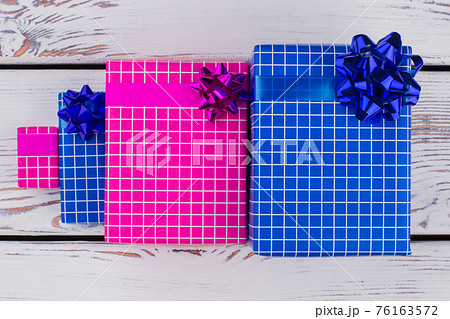Group of gift boxes on wooden background. Group of gift boxes on wooden background. 76163572