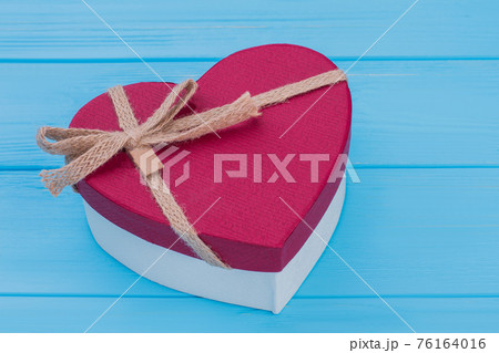 Red heart shaped gift box with bow. Red heart shaped gift box with bow. 76164016