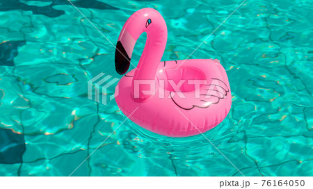 Summer sale. Pink inflatable flamingo in pool water for summer beach background. Minimal summer concept. 76164050