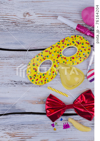 Kids party accessories on wood, top view. Kids party accessories on wood, top view. 76164204
