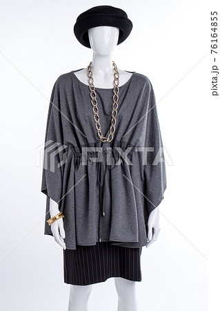 Female mannequin in black hat and grey tunic. Female mannequin in black hat and grey tunic. 76164855
