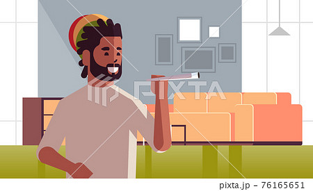 african american guy smoking cannabis marijuana joint drug consumption concept modern living room interior portrait horizontal 76165651