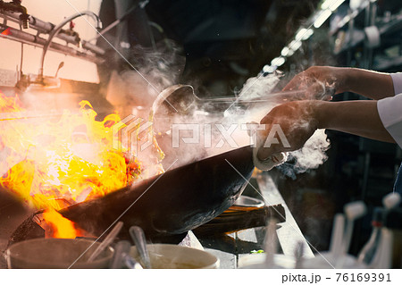 Chef stir fry busy cooking in kitchen 76169391