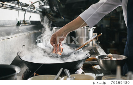 Chef stir fry busy cooking in kitchen 76169480