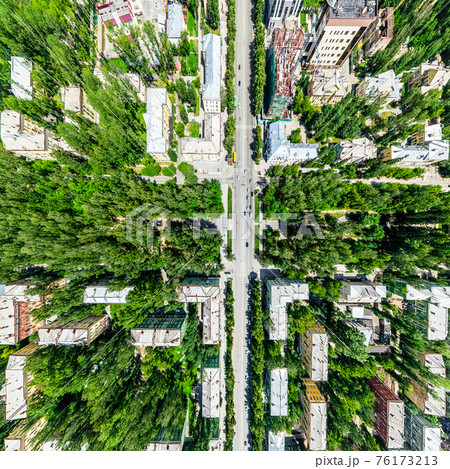 Aerial city view with crossroads and roads, houses, buildings, parks and parking lots. Sunny summer panoramic image Aerial city view with crossroads and roads, houses, buildings, parks and parking lots. Sunny summer panoramic image 76173213