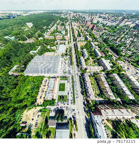 Aerial city view with crossroads and roads, houses, buildings, parks and parking lots. Sunny summer panoramic image Aerial city view with crossroads and roads, houses, buildings, parks and parking lots. Sunny summer panoramic image 76173215