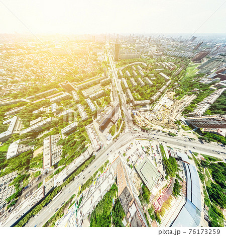 Aerial city view with crossroads and roads, houses, buildings, parks and parking lots. Sunny summer panoramic image Aerial city view with crossroads and roads, houses, buildings, parks and parking lots. Sunny summer panoramic image 76173259