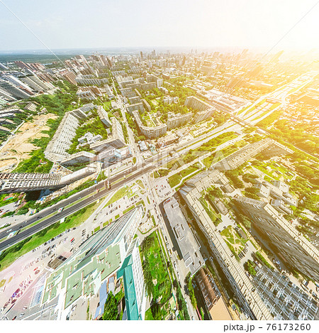 Aerial city view with crossroads and roads, houses, buildings, parks and parking lots. Sunny summer panoramic image Aerial city view with crossroads and roads, houses, buildings, parks and parking lots. Sunny summer panoramic image 76173260