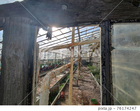 old abandoned greenhouse broken windows 76174247