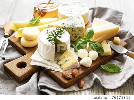 Various types of cheese  on a white wooden  background 76175315