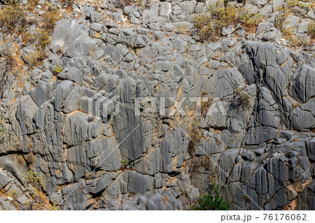 Natural texture of a mountain cliff rock for background Natural texture of a mountain cliff rock for background 76176062
