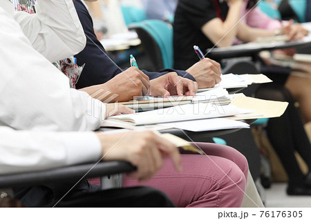 話を聴きながらペンを持つ男性の手元 話を聴きながらペンを持つ男性の手元 76176305